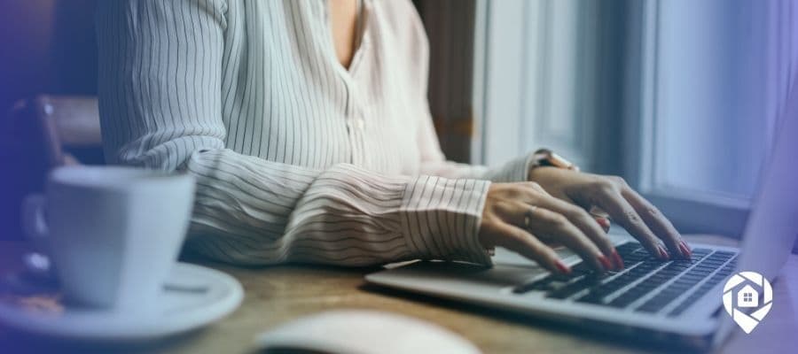 Woman researching virtual wholesaling and tax sale auctions on laptop for real estate investing.