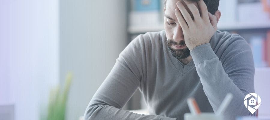 Frustrated real estate investor learning from costly mistakes.