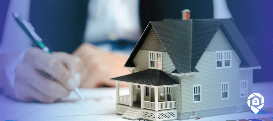 Real estate wholesaling strategy concept with model house and paperwork for scaling to 25 deals per month.