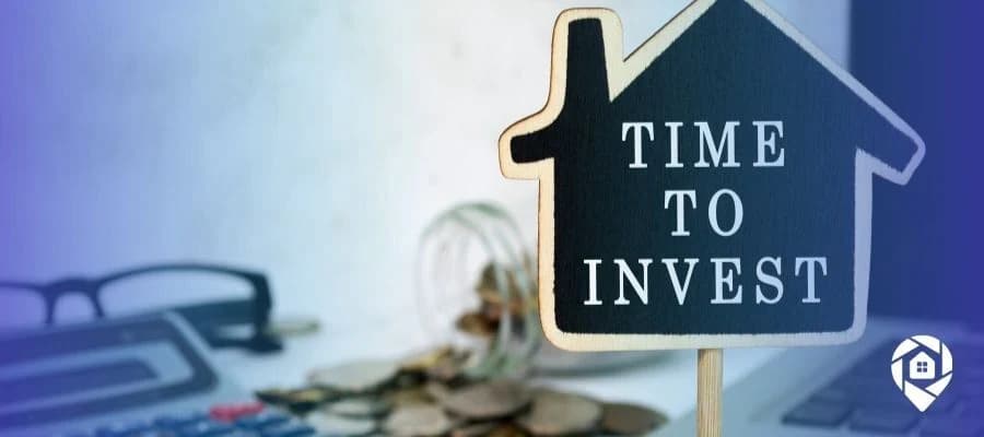 Time to invest in real estate sign with coins and calculator – start flipping, renting, or wholesaling properties for financial freedom.